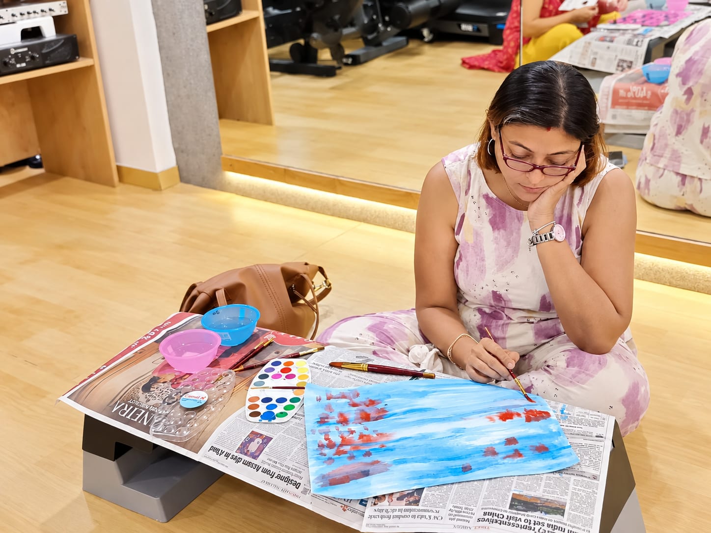 A woman painting in watercolour during a session at Jatan in Vadodara